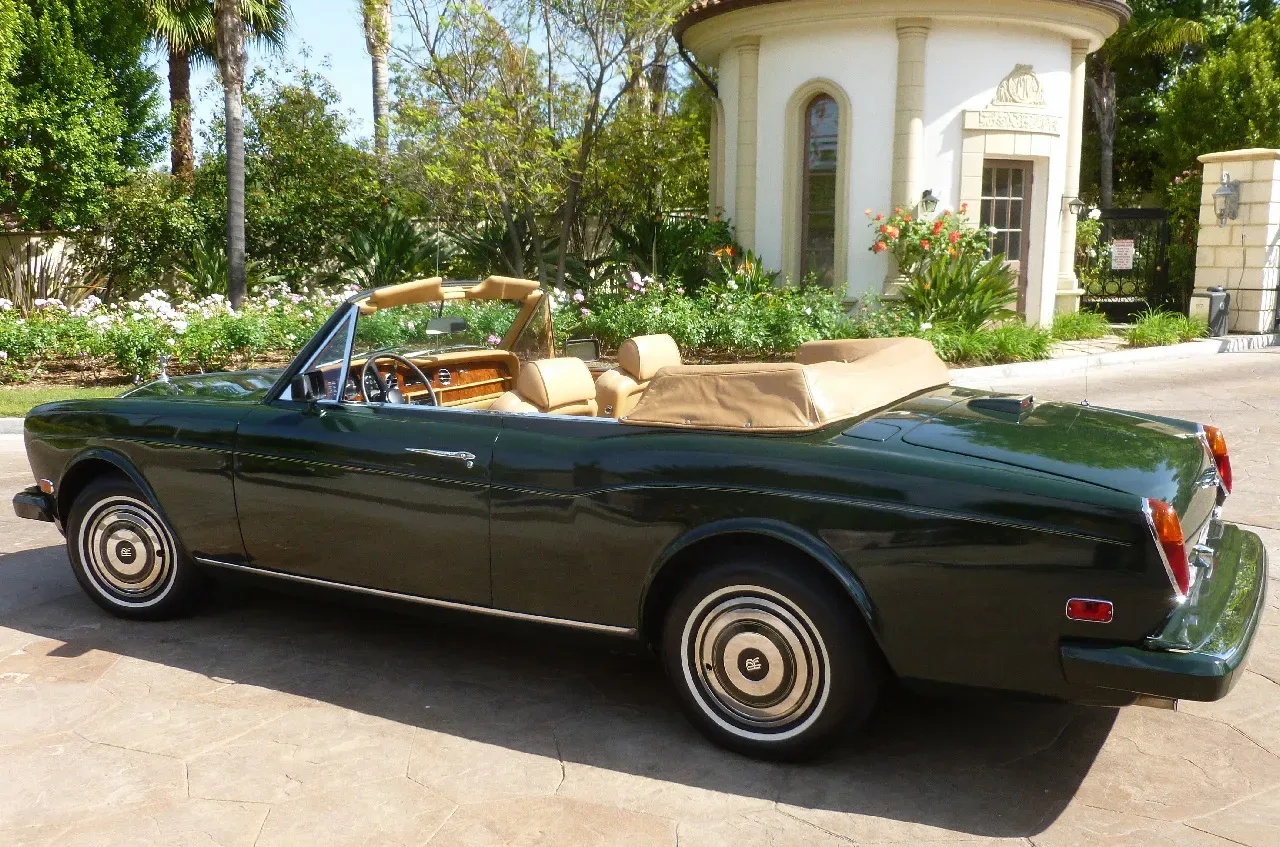 Green 1983 Rolls Royce Corniche Convertible exterior with convertible roof for wedding car rental