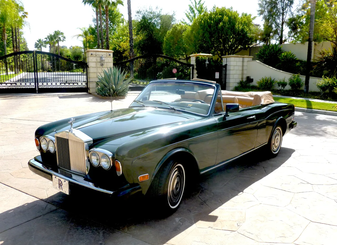 Green 1983 Rolls Royce Corniche Convertible with convertible roof for wedding car rental
