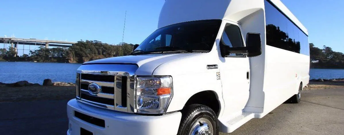 White Ford F-550 Party Bus exterior with tinted windows for limo rental in North Attleboro, MA