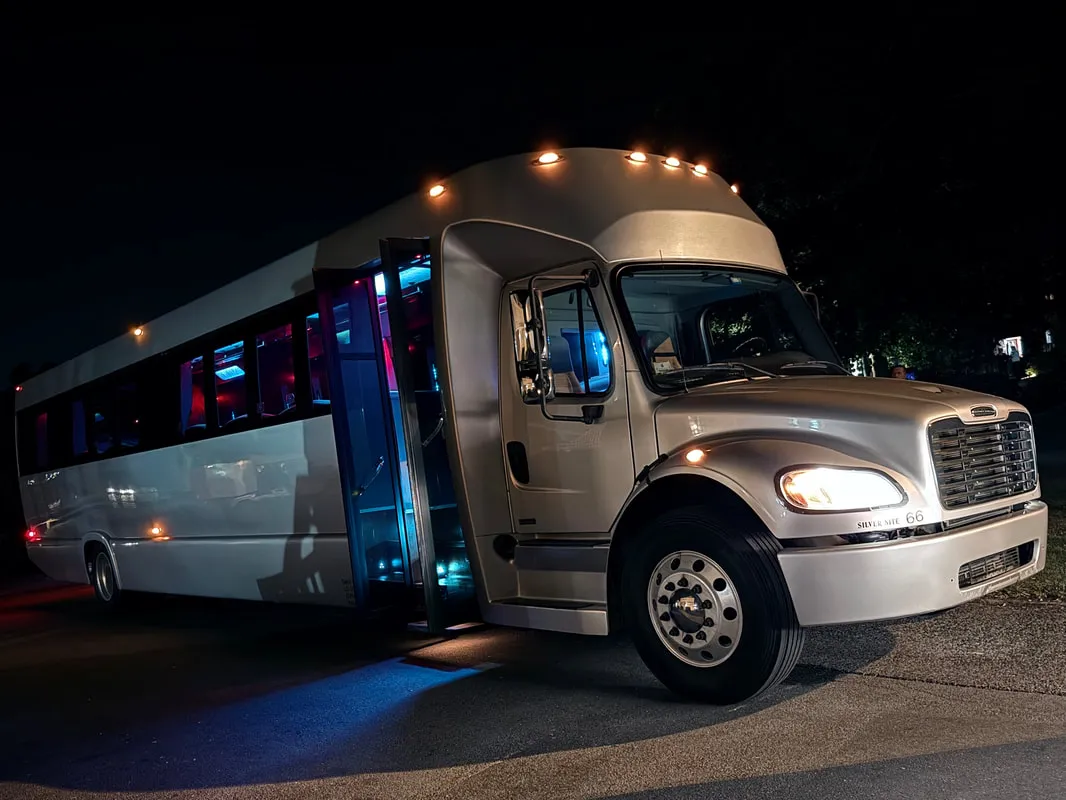 Silver Freightliner Party Bus exterior for limo rental in North Attleboro, MA