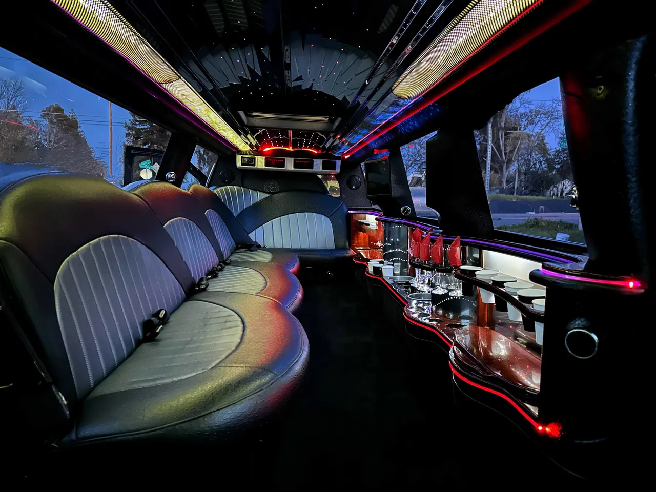 Cadillac Escalade Limo interior with LED accent lighting, LED ceiling lighting and bar area for limo rental