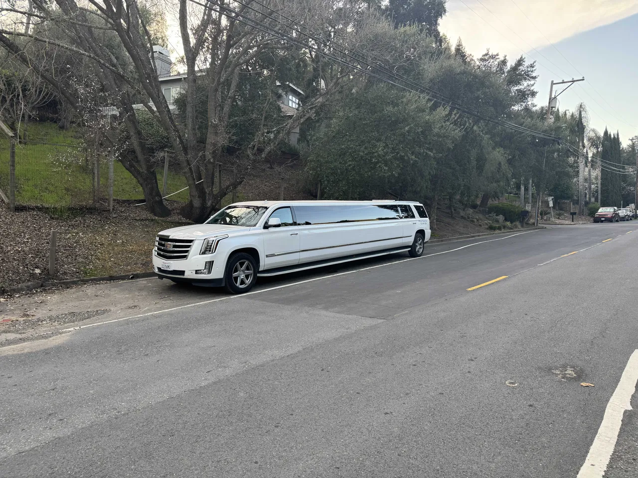 White Cadillac Escalade Limo with tinted windows for limo rental