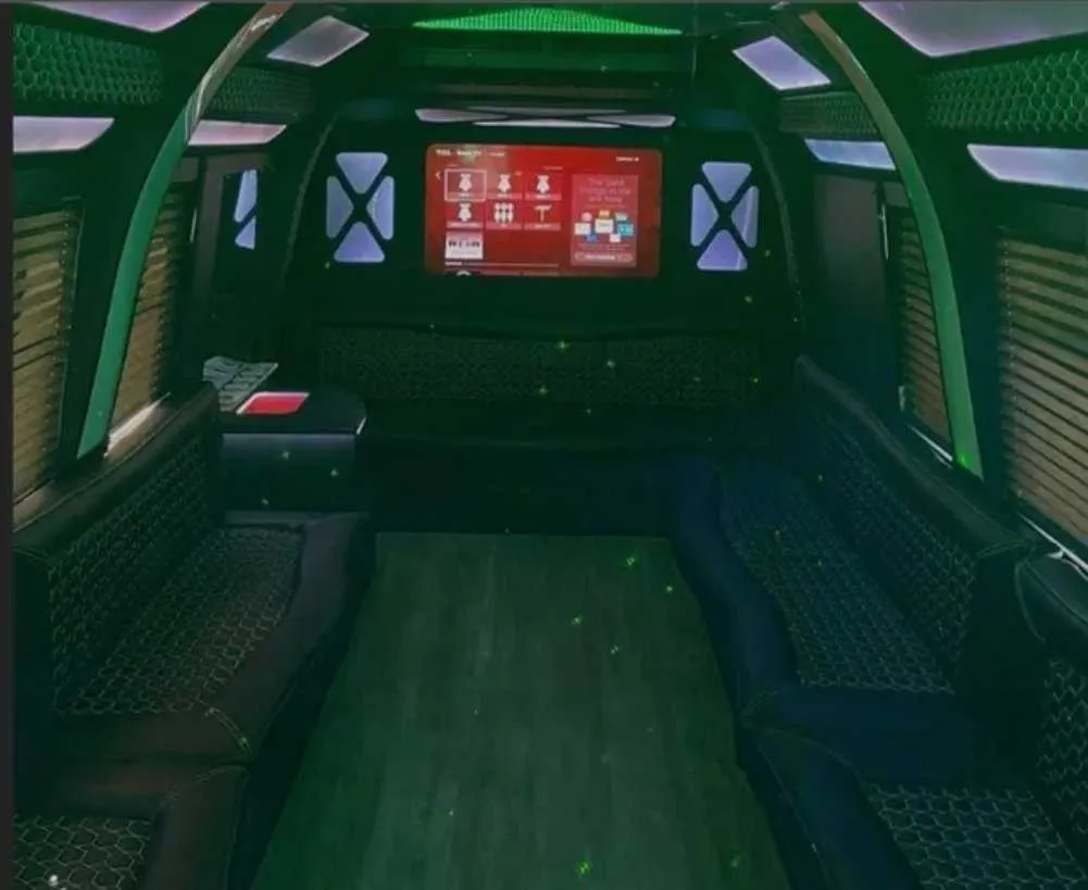 D-Town Bus limo rental, interior view: perimeter lounge seating, window shades and LED accent lighting