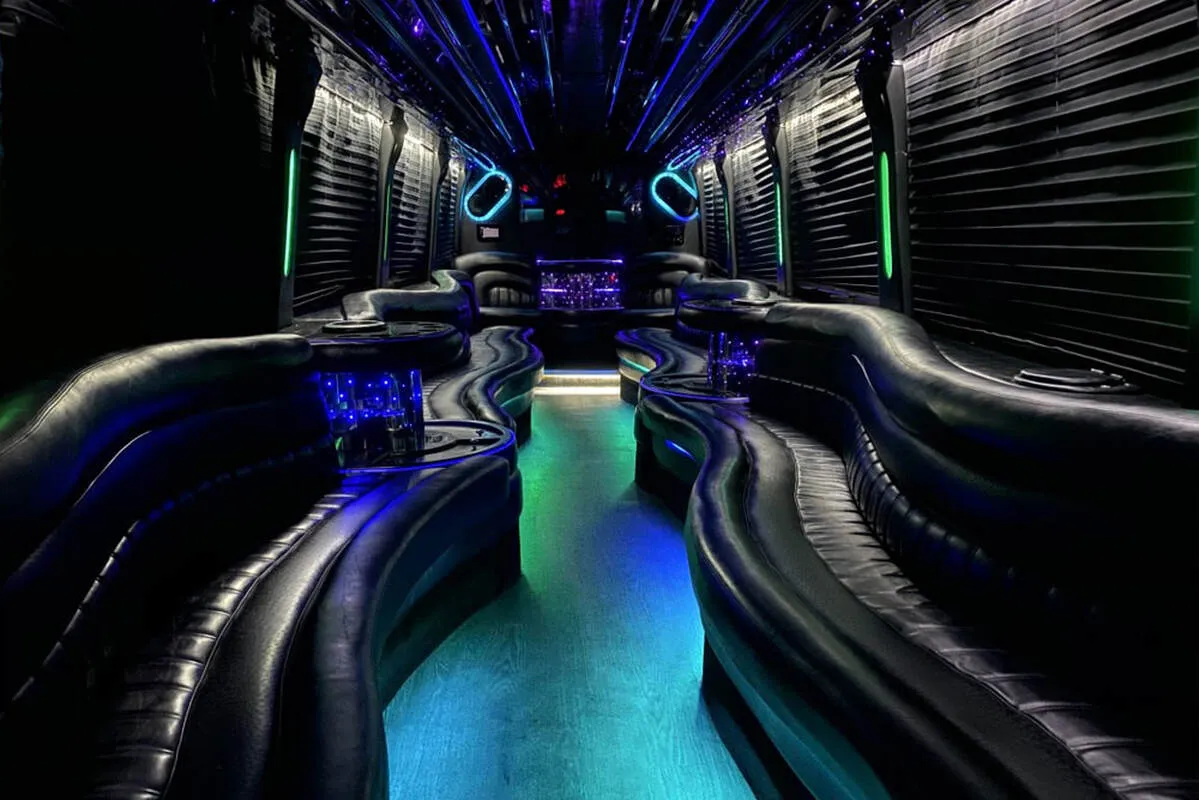 Entertainment Coach interior with perimeter lounge seating, window shades and LED accent lighting for limo rental in North Attleboro, MA