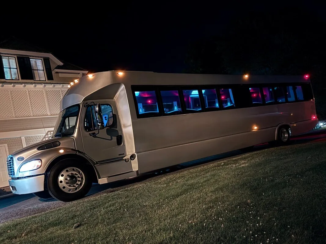 Silver Freightliner Party Bus exterior with tinted windows, photo 6 for limo rental in North Attleboro, MA