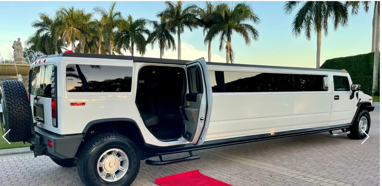 White Hummer H2 15 Pass with tinted windows and running boards for limo rental