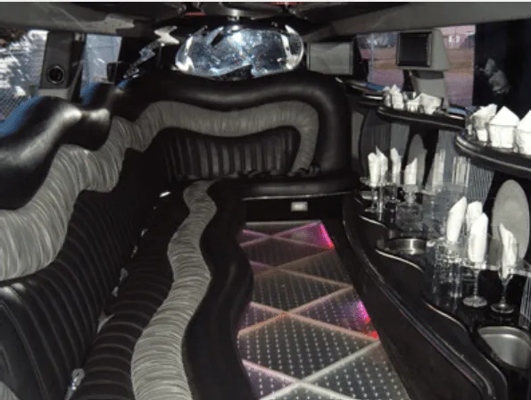 Hummer Limousine rental, interior view: lit dance floor and bar area