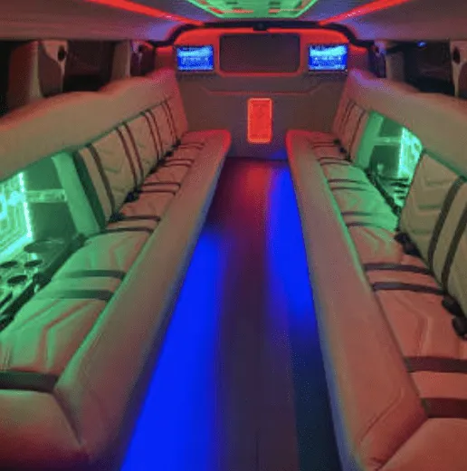Hummer Limousine rental, interior view: perimeter lounge seating, LED accent lighting and TV screens