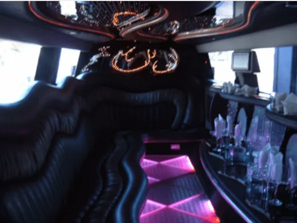 Hummer Limousine rental, interior view: lit dance floor and bar area #3