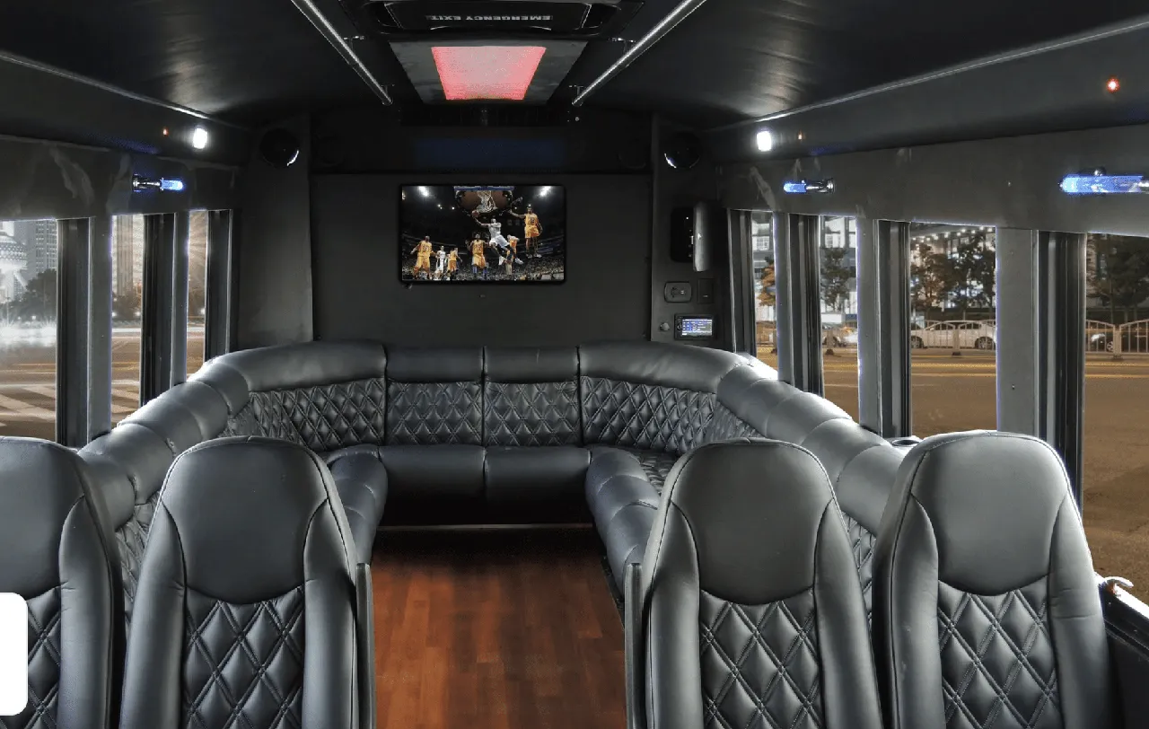 Limousine Coach rental, interior view: perimeter lounge seating, sofa-style seating and wood-look flooring