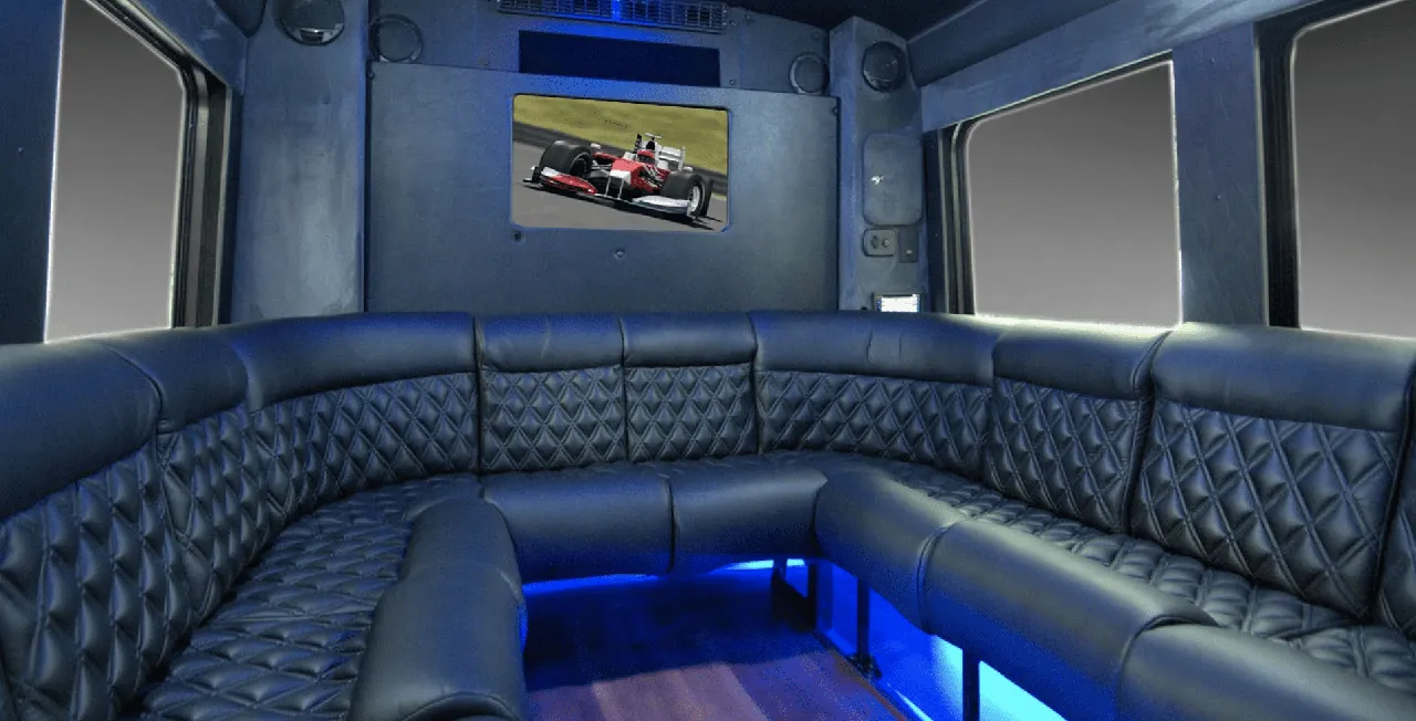 Limousine Coach rental, interior view: perimeter lounge seating, sofa-style seating and LED accent lighting