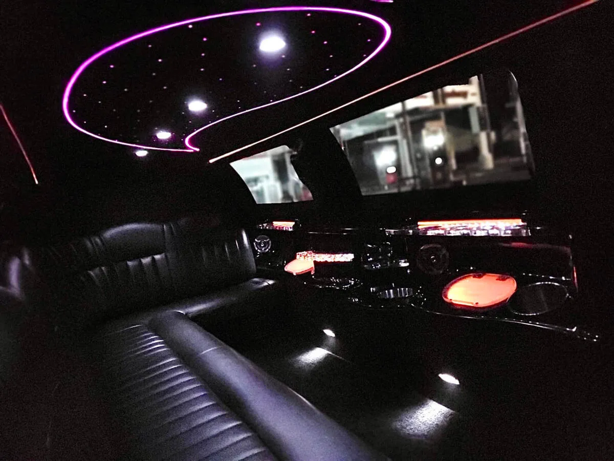 Lincoln Town Car Limousine interior with perimeter lounge seating and starlight or fiber-optic ceiling, photo 8 for limo rental