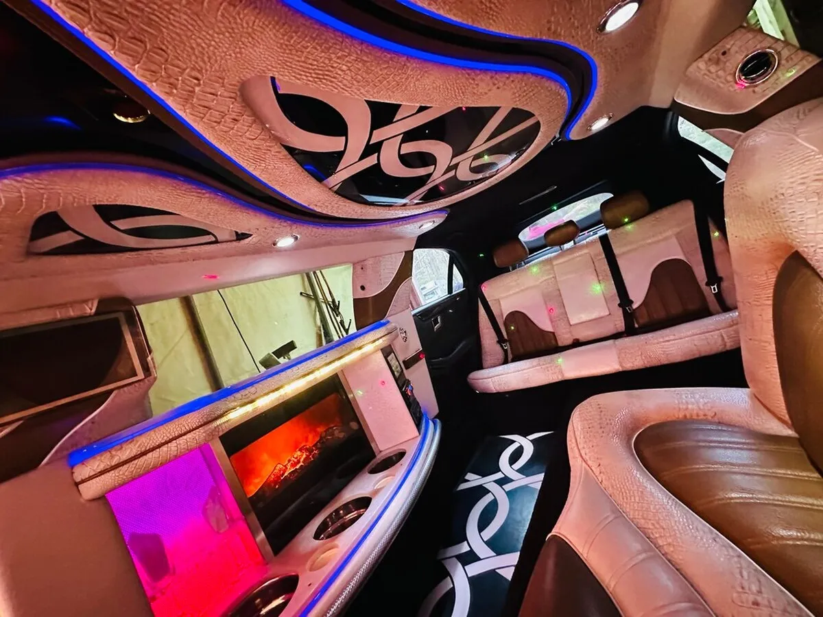 Mercedes-Benz Jet Doors Limousine interior with perimeter lounge seating and LED accent lighting for limo rental in North Attleboro, MA