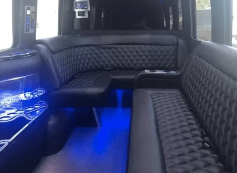 Mercedes-Benz Limousine Sprinter rental, interior view: sofa-style seating, cup holders and LED accent lighting