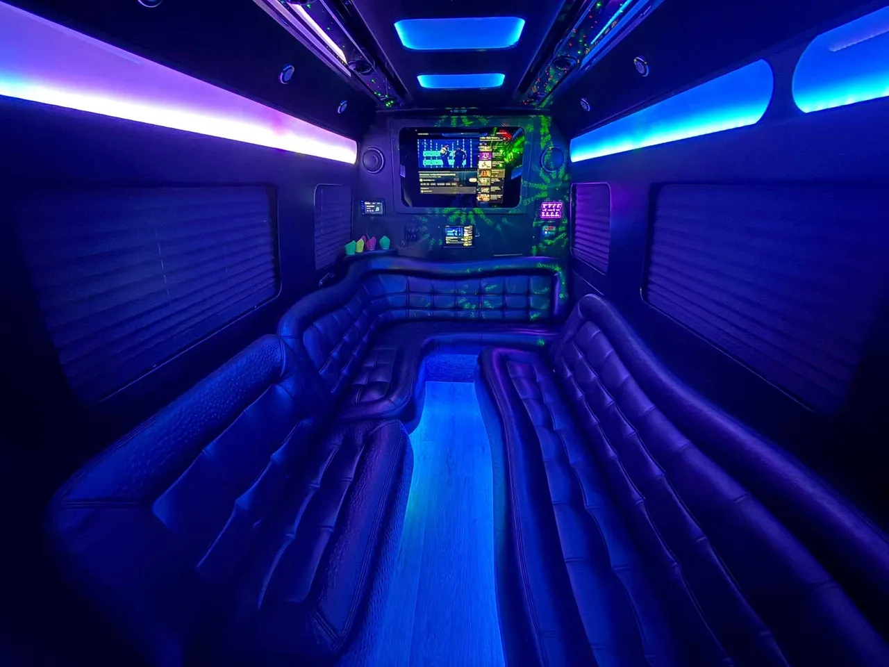 Mercedes-Benz Limousine Sprinter interior with perimeter lounge seating, window shades and LED accent lighting for limo rental in Rosedale, NY
