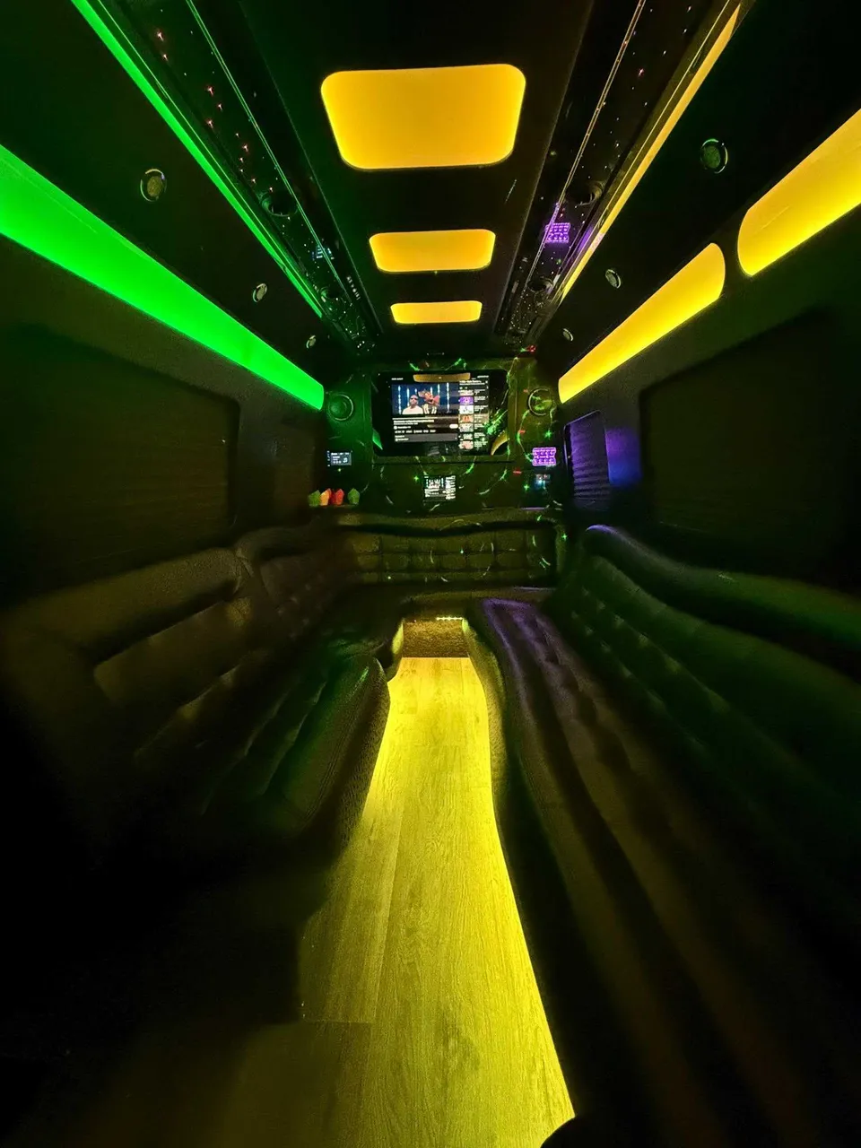 Mercedes-Benz Limousine Sprinter interior with perimeter lounge seating, LED accent lighting and LED ceiling lighting for limo rental in Rosedale, NY