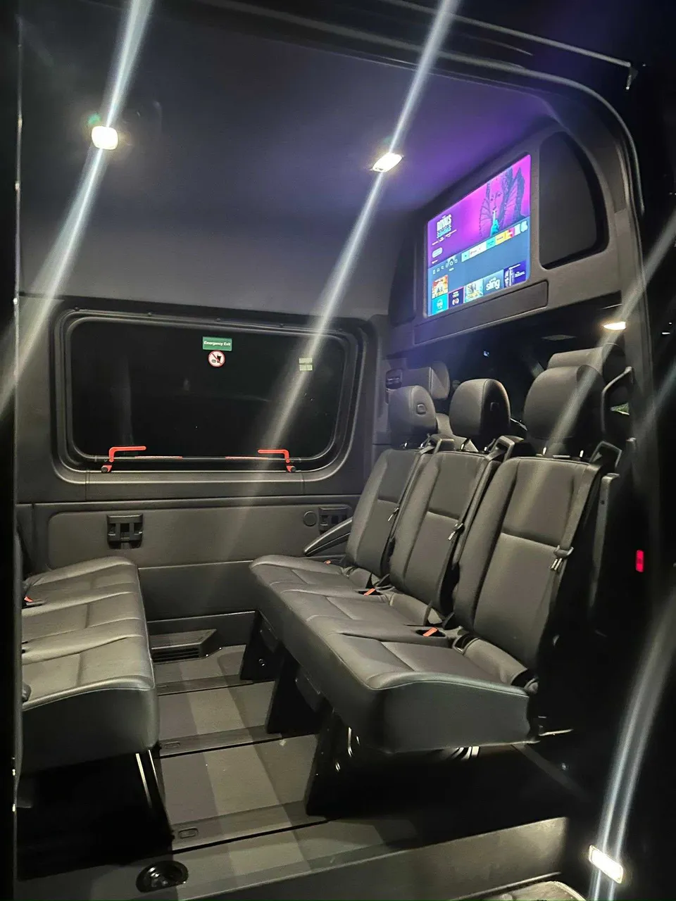 Mercedes-Benz Limousine Sprinter rental, interior view: TV screens and passenger seat belts