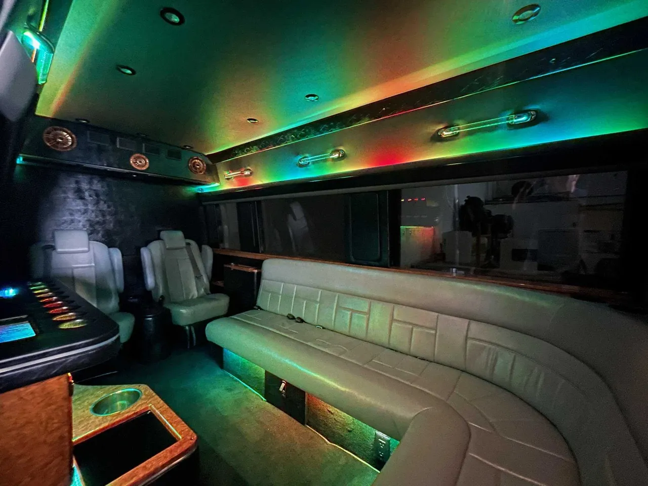 Mercedes-Benz Sprinter Limousine rental, interior view: sofa-style seating, captain's chairs and LED accent lighting