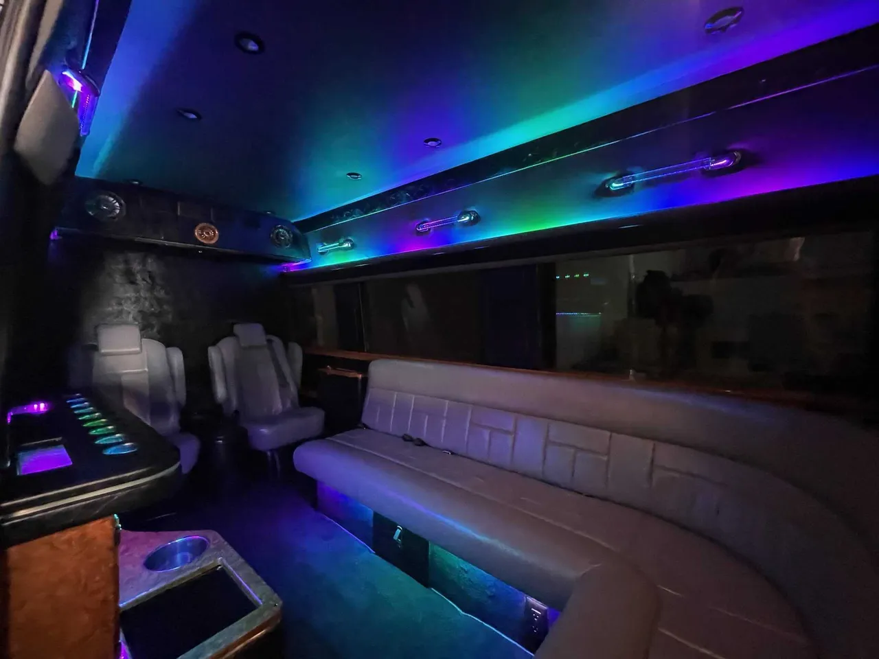 Mercedes-Benz Sprinter Limousine rental, interior view: sofa-style seating, captain's chairs and LED accent lighting #2