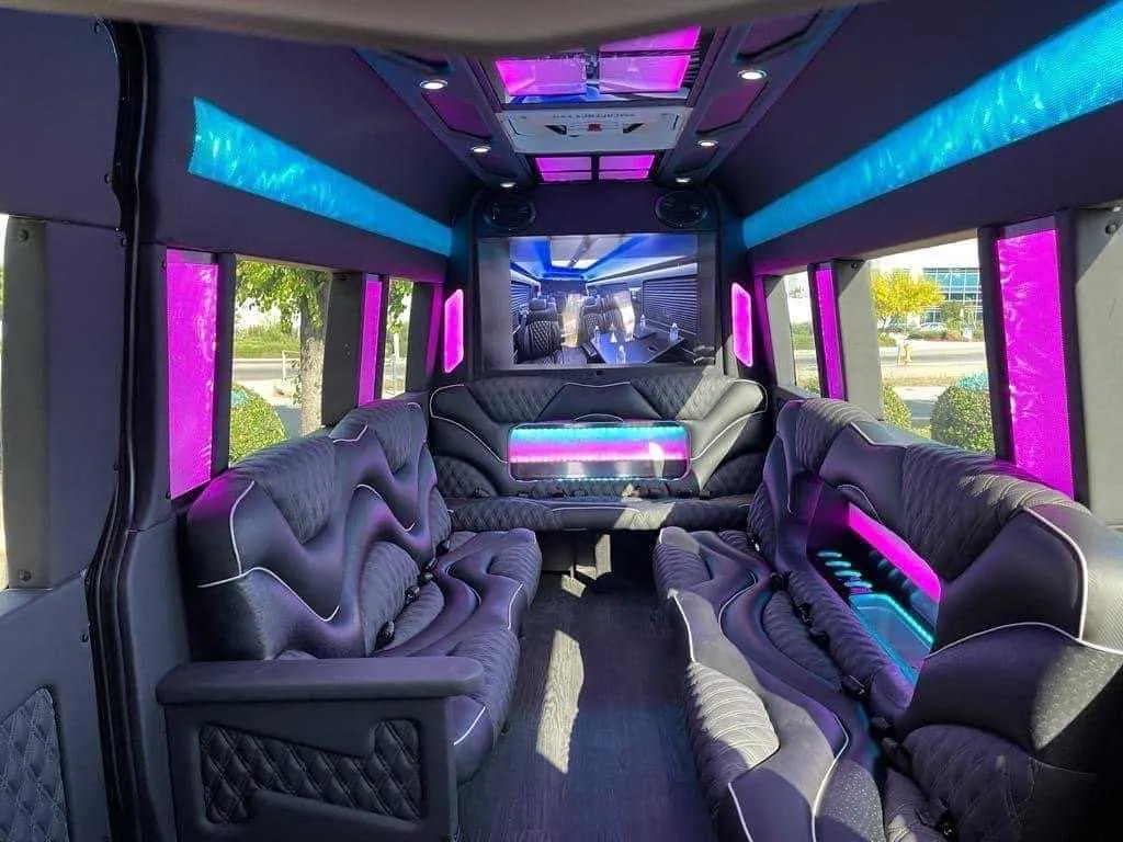 Mercedes-Benz Sprinter Limousine rental, interior view: sofa-style seating, LED accent lighting and LED ceiling lighting