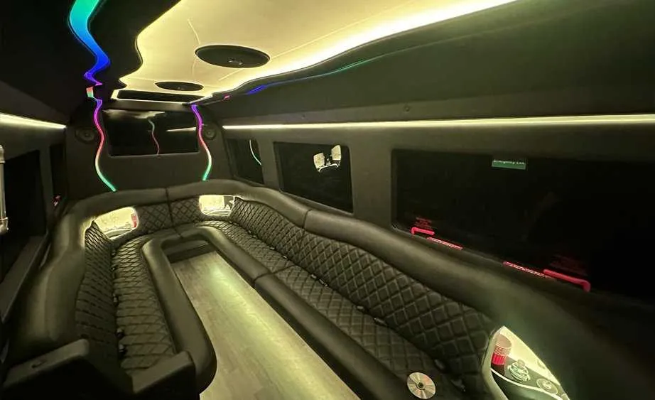 Mercedes-Benz Sprinter Limousine rental, interior view: perimeter lounge seating, LED accent lighting and bar area