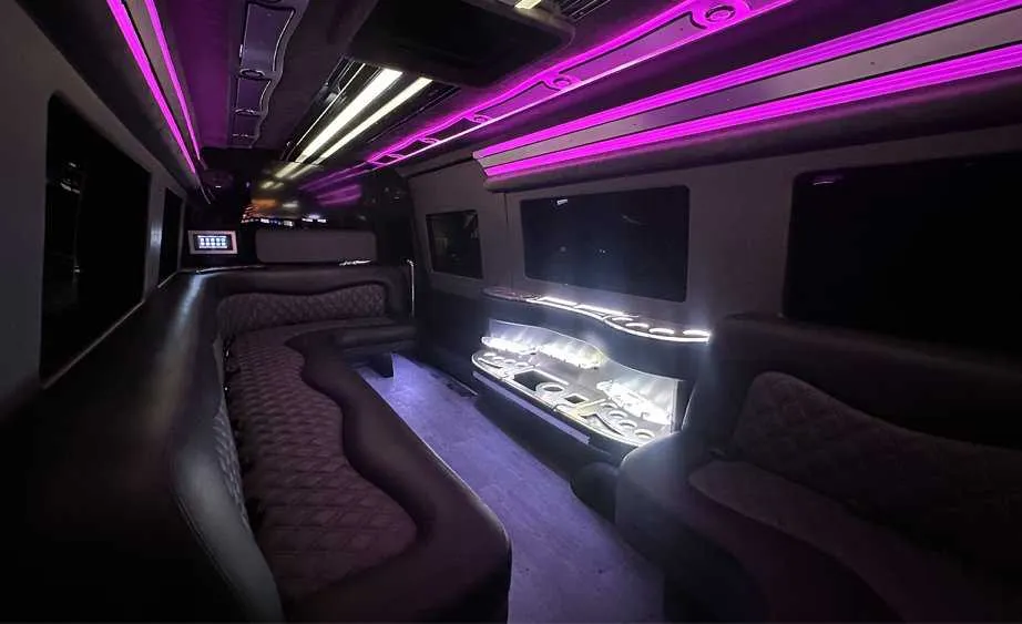 Mercedes-Benz Sprinter Limousine rental, interior view: perimeter lounge seating, LED accent lighting and bar area #3