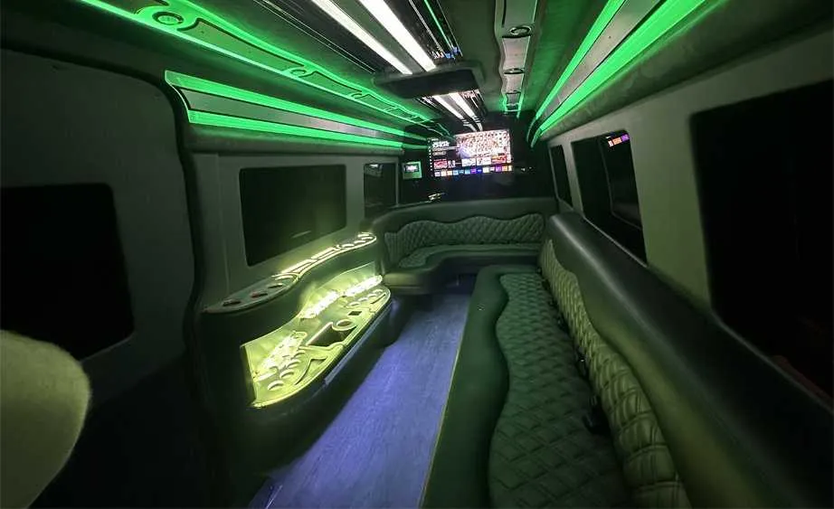 Mercedes-Benz Sprinter Limousine rental, interior view: perimeter lounge seating, LED accent lighting and bar area #4