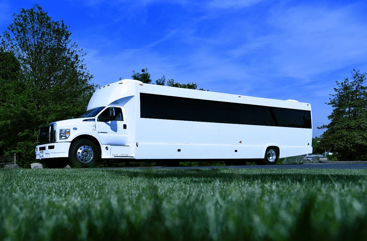 White 50 Passenger Party Bus exterior with tinted windows for limo rental in Queens Village, NY