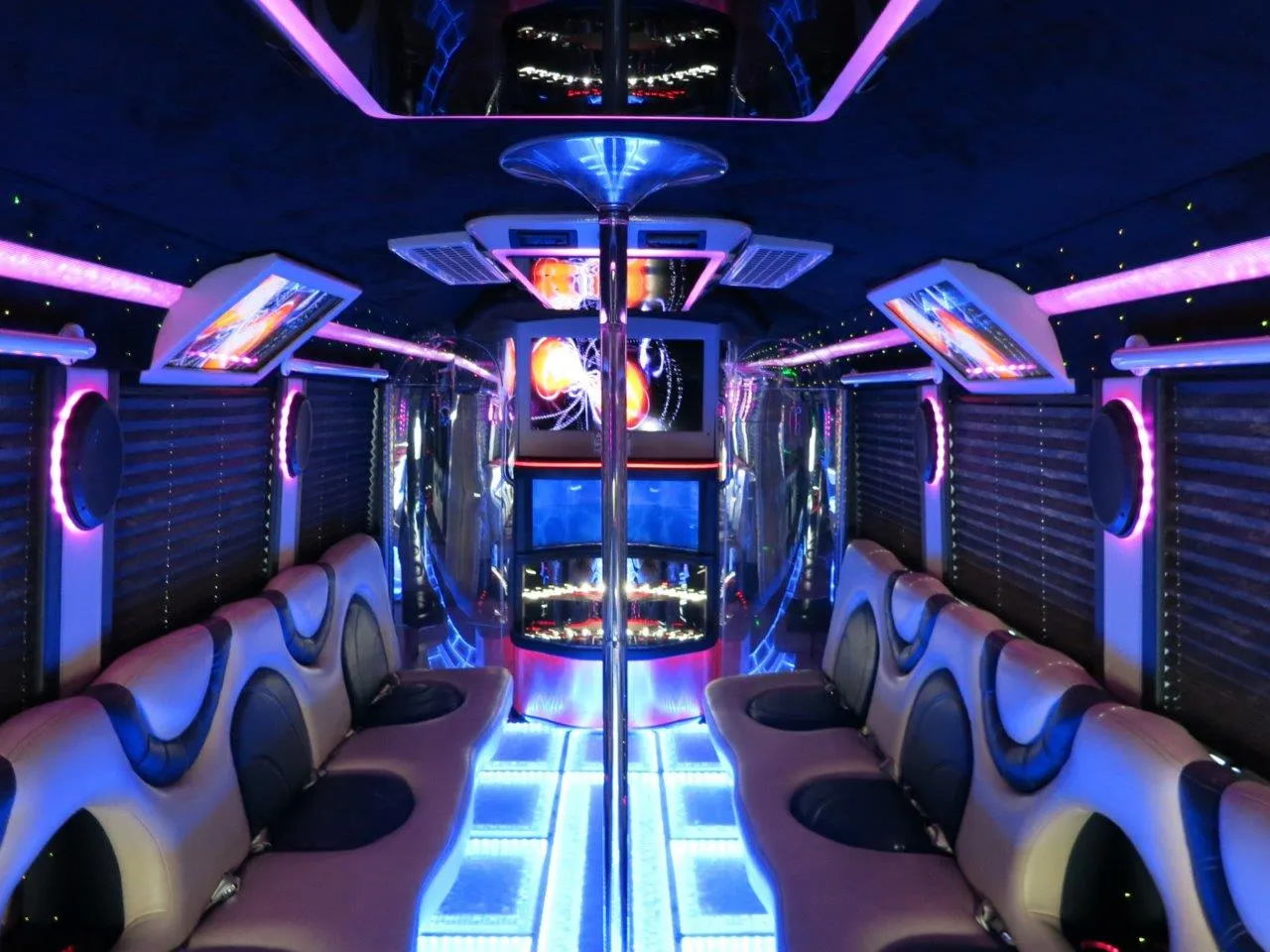 26 Passenger Party Bus limo rental, interior view: perimeter lounge seating, window shades and LED accent lighting