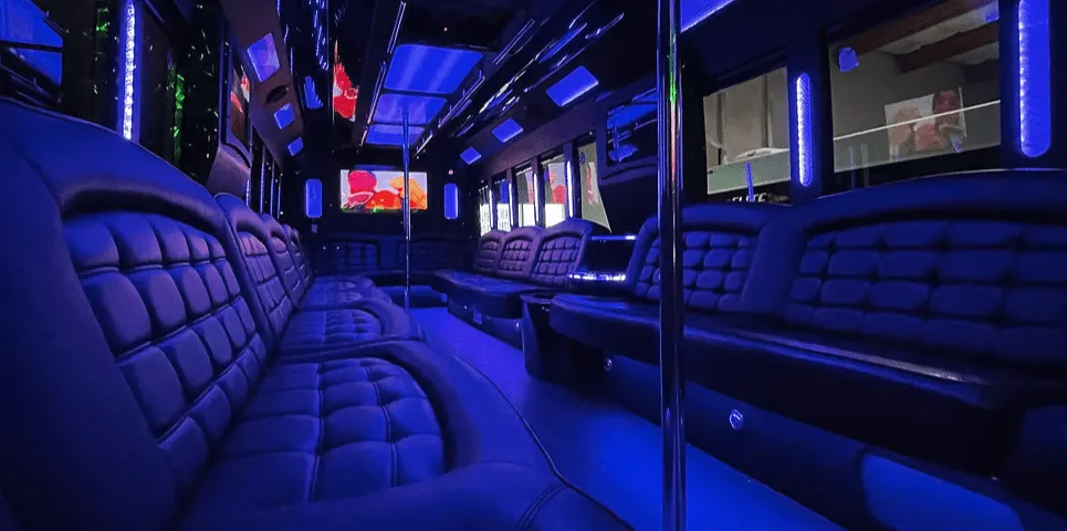 26 Passenger Party Bus limo rental, interior view: perimeter lounge seating, LED accent lighting and LED ceiling lighting