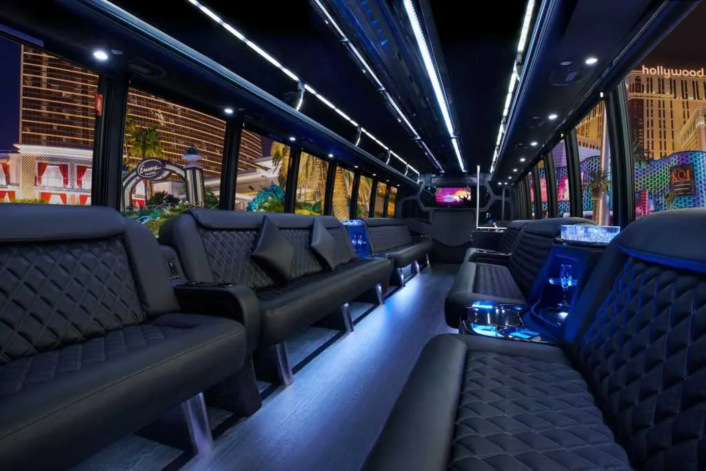 30 Passenger Party Bus limo rental, interior view: perimeter lounge seating, LED accent lighting and LED ceiling lighting