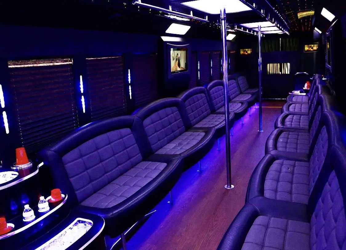 Tiffany Party Bus limo rental, interior view: perimeter lounge seating, window shades and LED accent lighting