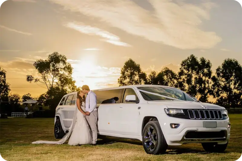 Newlyweds beside a white stretch limousine — Special Occasions
